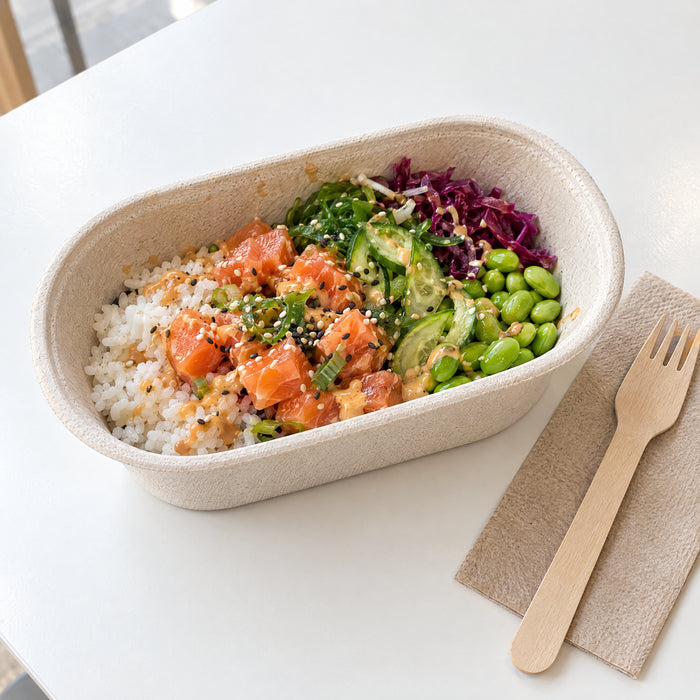 Salmon poke in a bagasse oval bowl with a wooden fork