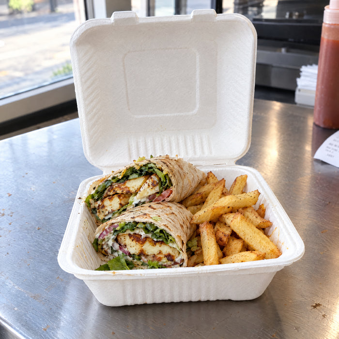Halloumi wrap and chips in a bagasse 9 inch clamshell on a takeaway counter