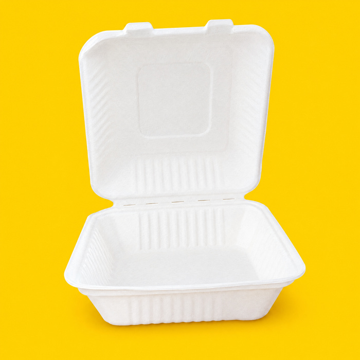 White bagasse 9 inch hinged clamshell, open, on yellow