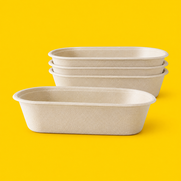 Stack of natural bagasse oval shallow salad bowls 650ml on yellow