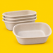Stack of natural bagasse oval deep salad bowls 900ml, on yellow