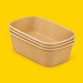 Stack of brown kraft rectangular salad bowls 500ml, on yellow