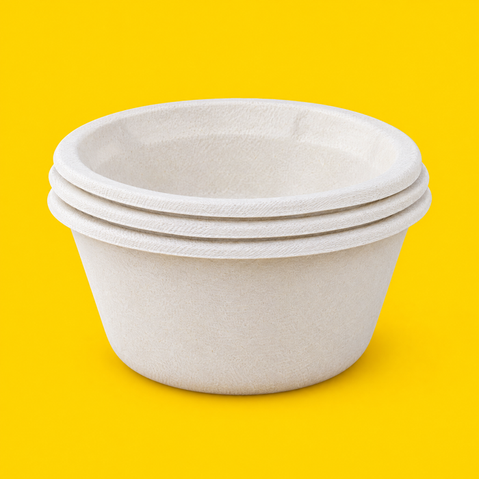 Stack of natural bagasse round bowls 1000ml, on yellow