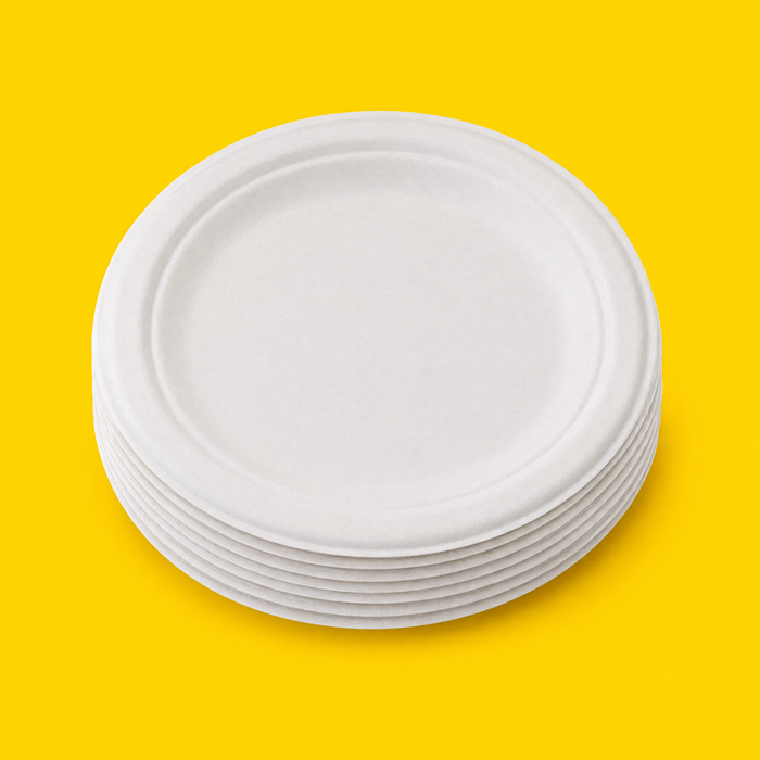 Stack of white bagasse 7 inch round plates, on yellow