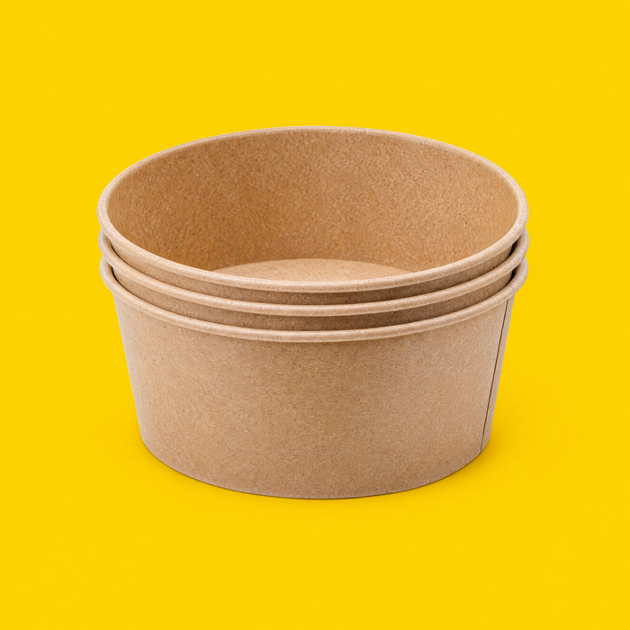 Stack of brown kraft round salad bowls 750ml, on yellow