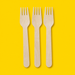 Three birchwood wooden forks, on yellow