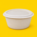 Natural bagasse lid fitted on a 1500ml round bowl, on yellow