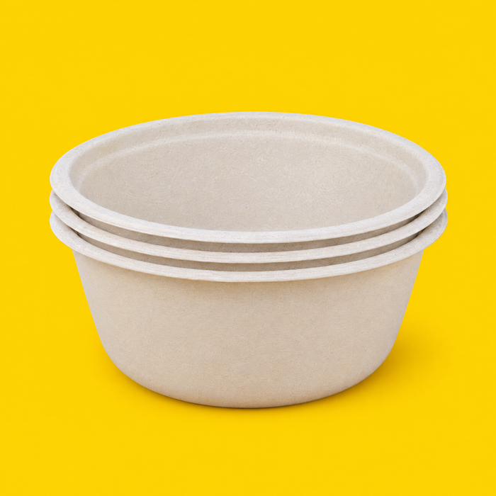 Stack of natural bagasse round bowls 1500ml, on yellow