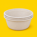 Stack of natural bagasse round bowls 1500ml, on yellow