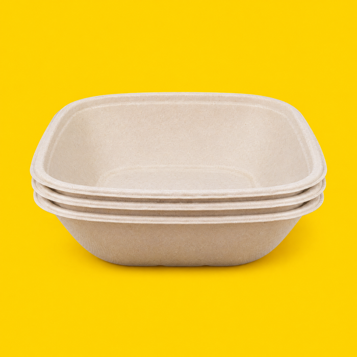 Stack of natural bagasse square bowls 1000ml, on yellow