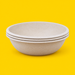 Stack of natural bagasse round bowls 750ml, on yellow