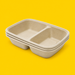 Stack of natural bagasse 2-compartment trays 900ml, on yellow