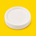 Stack of white bagasse 10 inch plates, on yellow