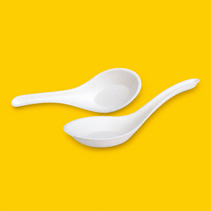 Two white bagasse Chinese soup spoons 140mm, on yellow