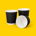 Three black double wall espresso cups 120ml (4oz), on yellow