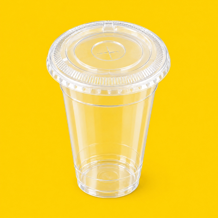 Clear PET flat lid fitted on a 12oz cold cup, on yellow