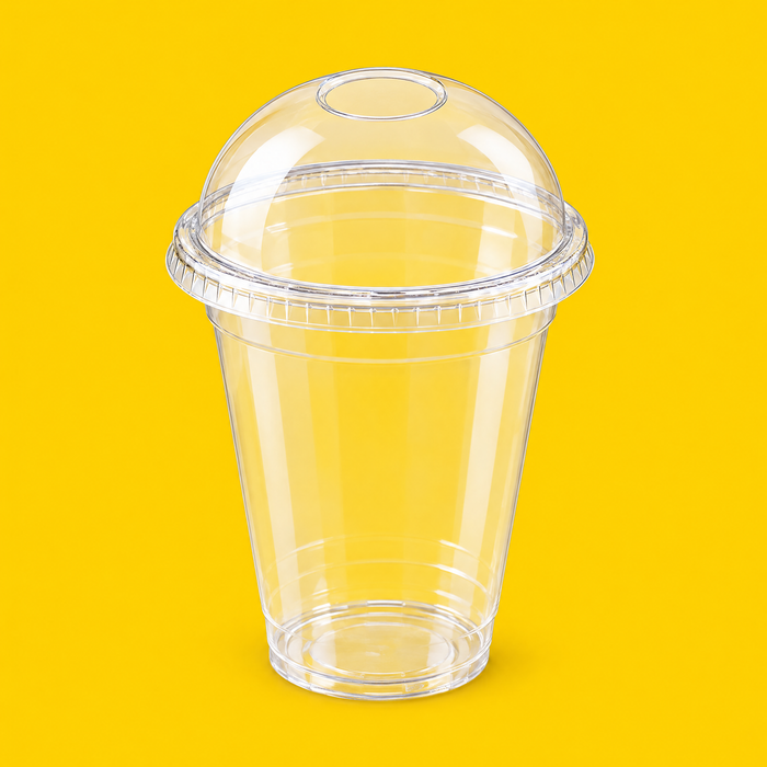 Clear PLA dome lid fitted on a 16oz PLA cold cup, on yellow