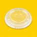 Clear rPET flat lid for smoothie cup, on yellow