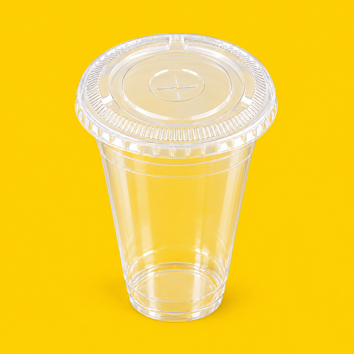 Clear PLA flat lid fitted on a 16oz PLA cold cup, on yellow