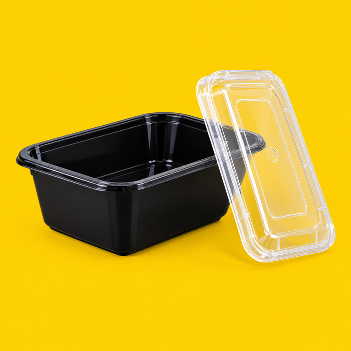 Black rectangular food container 1000ml with its clear lid, on yellow