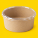 Clear PP lid fitted on a 1300ml kraft salad bowl, on yellow
