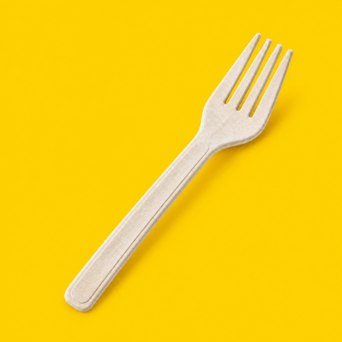 Close-up of a natural bagasse fork 162mm, on yellow