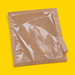 Close-up of a kraft film front paper bag, on yellow