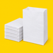 White block bottom paper bags, one open, on yellow