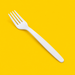 Close-up of a white cornstarch fork, on yellow